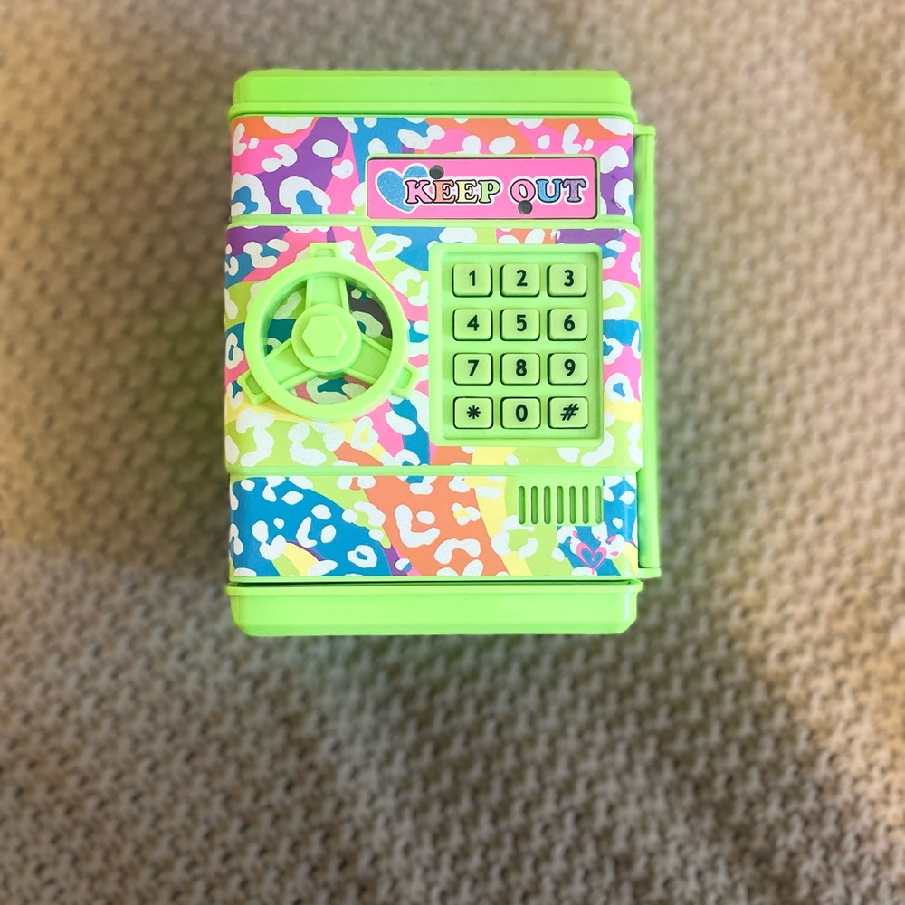 Justice neon green piggy bank with paddle number lock